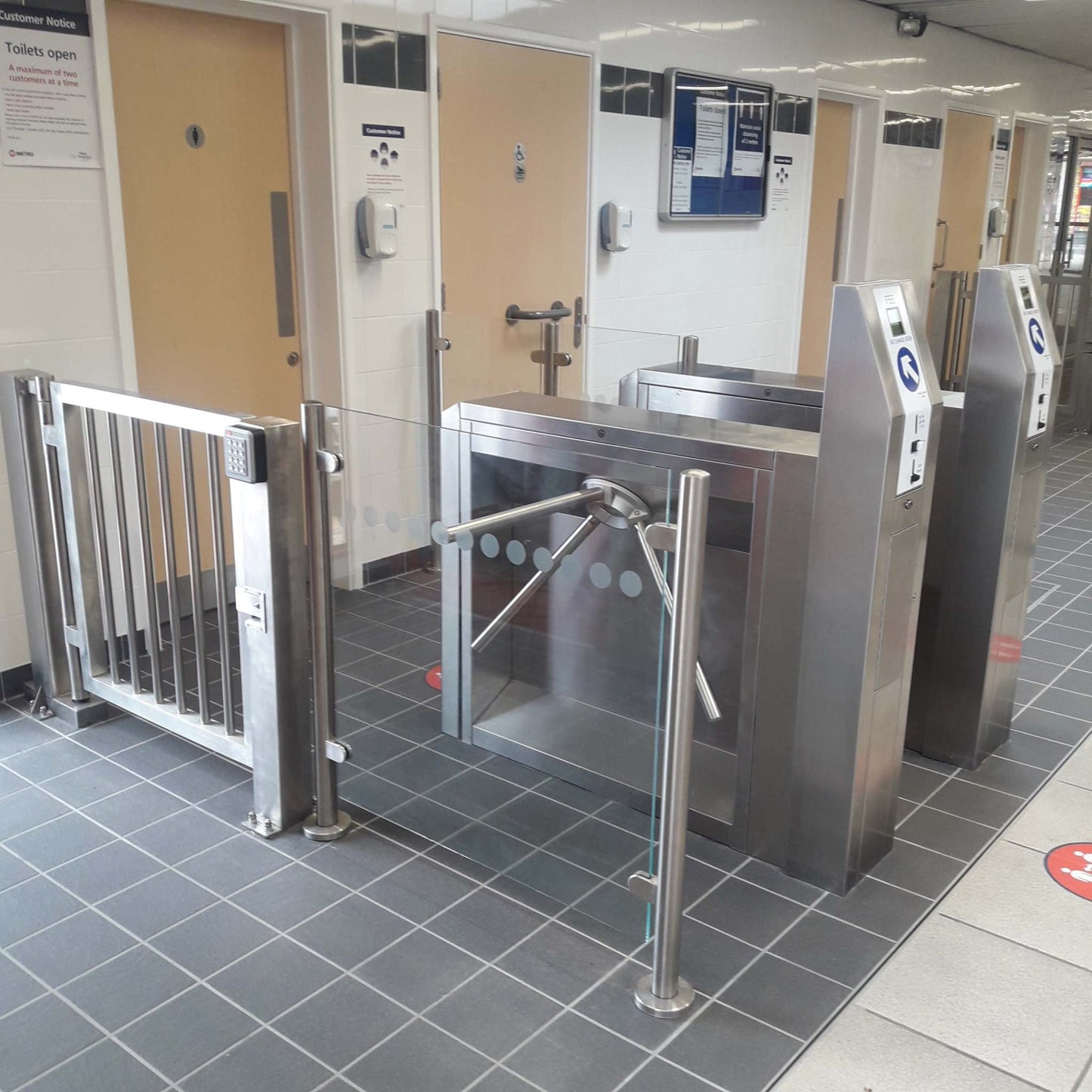 TT300 Coin Operated Turnstile with security gates in indoor setting.
