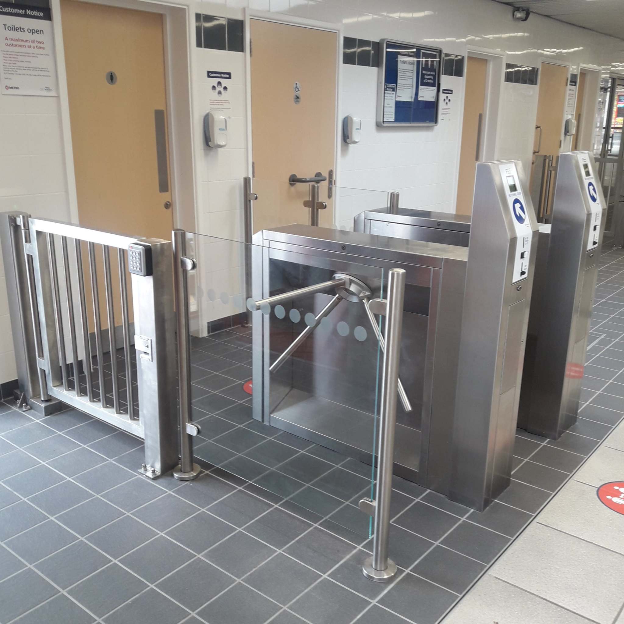 TT300 Coin Operated Turnstile with security gates in indoor setting.