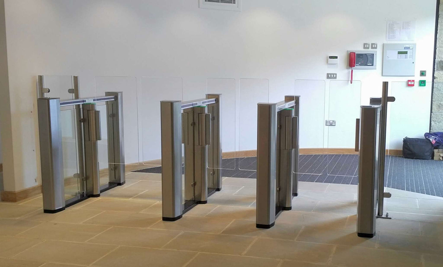 Evolve PG150 Speed Lane Gate with transparent Plexiglas obstacles for bidirectional pedestrian flow, suitable for corporate environments.