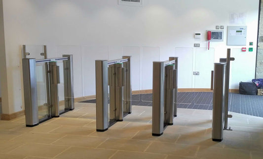 Evolve PG150 Speed Lane Gate with transparent Plexiglas obstacles for bidirectional pedestrian flow, suitable for corporate environments.