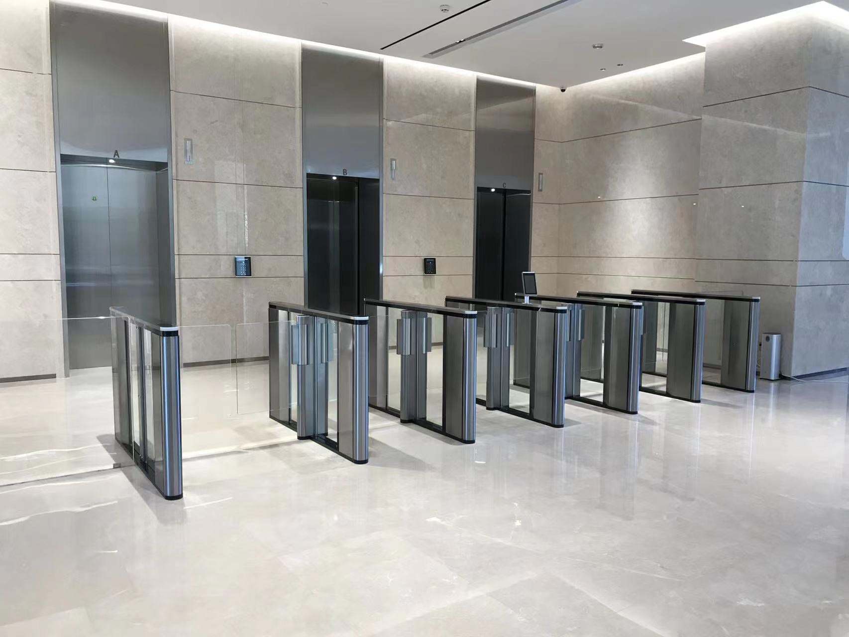 Evolve PG500 Paddle Gate in sleek corporate building setting, designed for high-speed, bi-directional pedestrian access with security features.